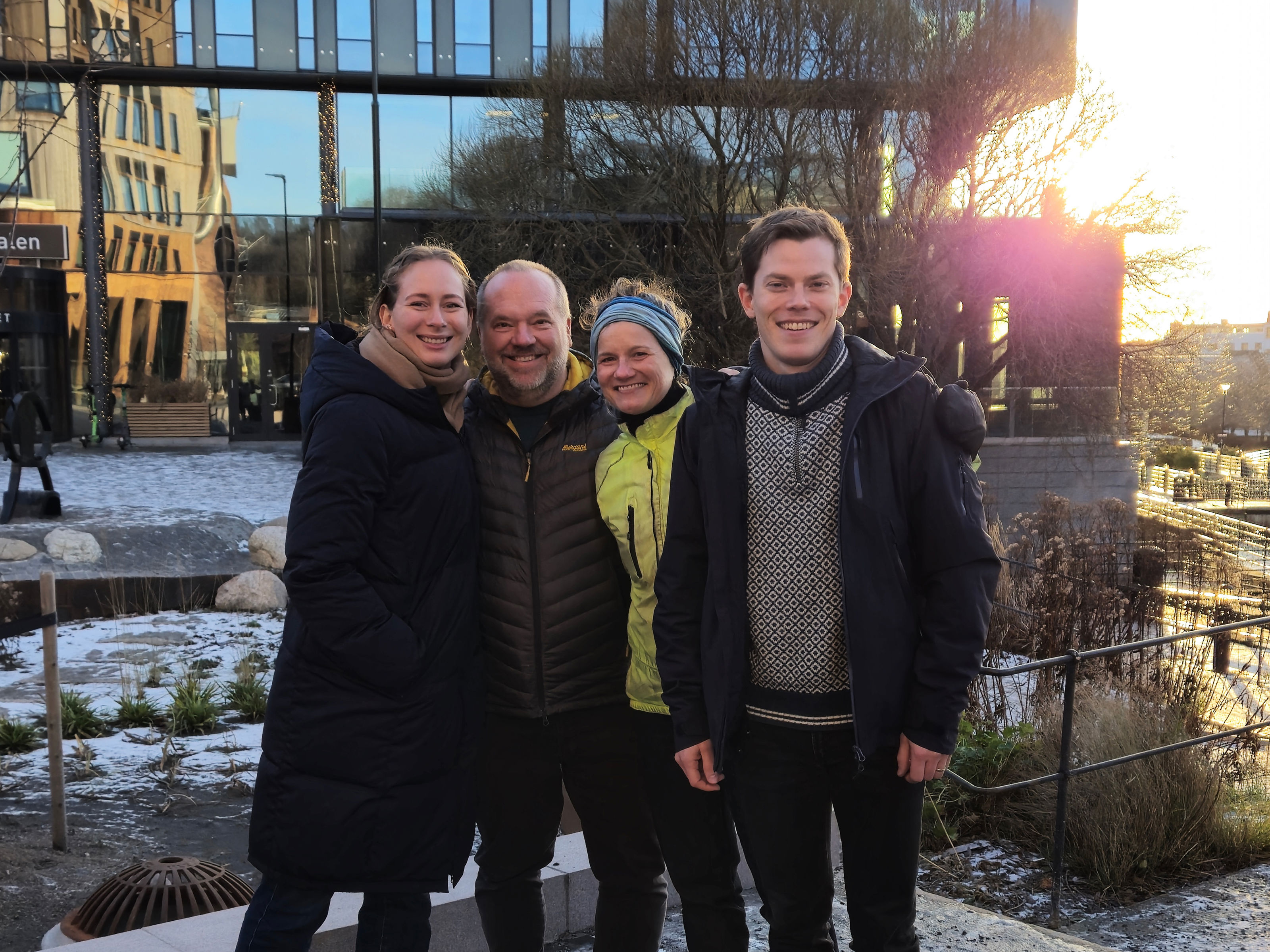 A group of four people posing for the camera.